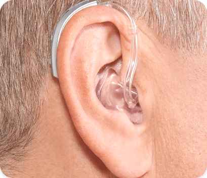 Display of how the behind-the-ear hearing aid looks on someone