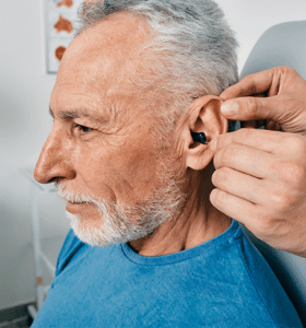 Man getting his hearing aid fitted