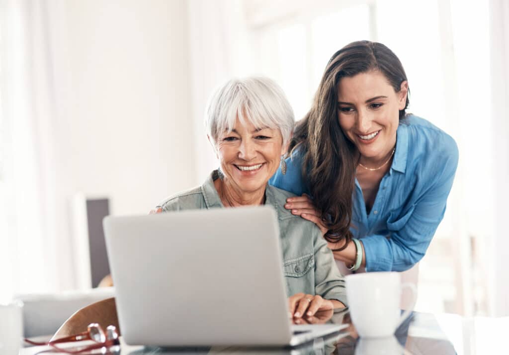Young woman and her older mother using a laptop