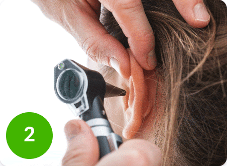 Woman getting her ear examined at the doctor's office